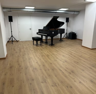 a piano player is in a big room with wood floor