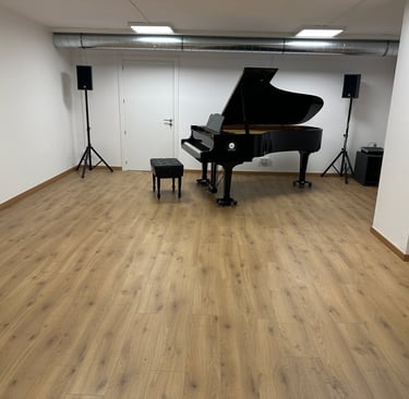 a piano player is in a big room with wood floor
