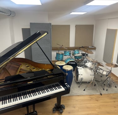 a piano and drums in a room with a latin percussion
