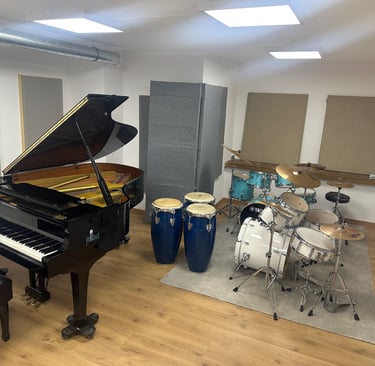 a piano and drums in a room with a latin percussion