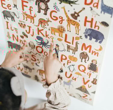 child is pointing at letters