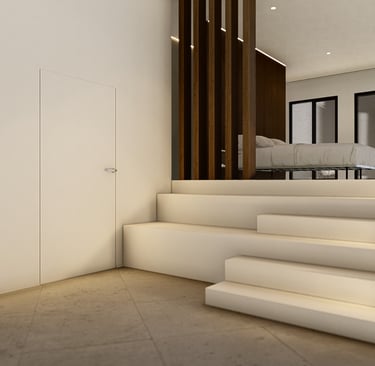 a modern home with a large white kitchen and stairs