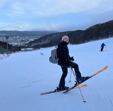 a girl laughing and skiing in sapporo hokkaido japan