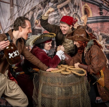 Shank Painters having an arm wrestling match, four pirates shouting