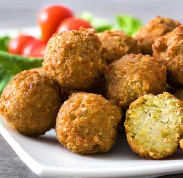a white plate filled with falafel