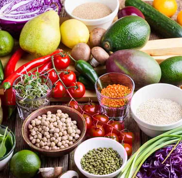 selection of plant based fruit, beans, vegetables, lentils