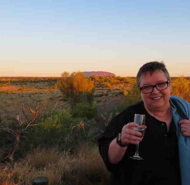 Nella at Uluru with a glass of champagne in hand