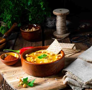 rustic bowl with chickpea curry and small spice bowls