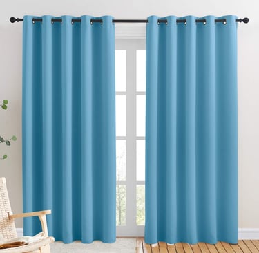 a blue curtain with a chair and a rocking chair