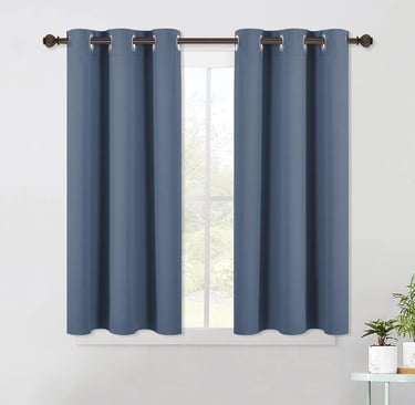 a curtain with a blue curtain and a potted plant