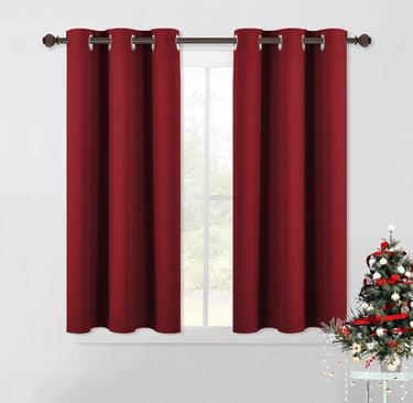 a christmas tree with a red curtain and a christmas tree