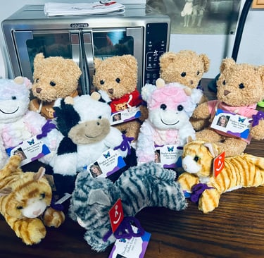 a bunch of stuffed animals sitting on a table