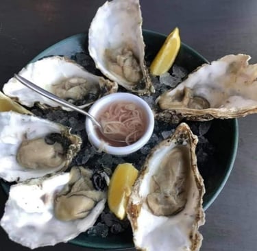 Oysters served to wedding guests on a bed of ice with shallot mignonette