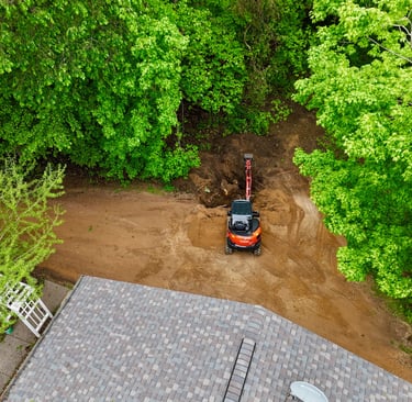 Kubota excavator digging dirt at residential home in central mn