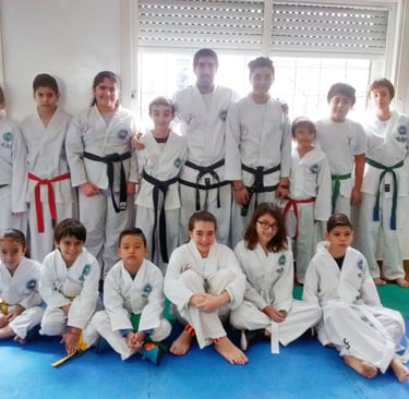 a group of kids and adults in karate gear