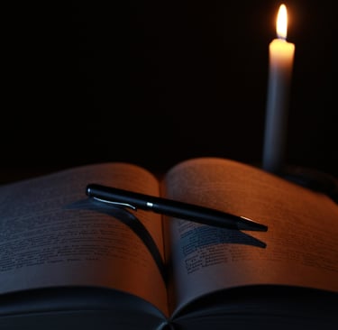 book and pen in candle light