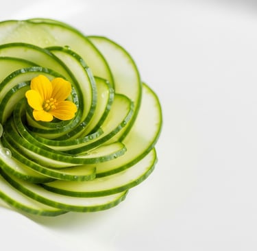a spiral cut cucumber flower garnish on a plate