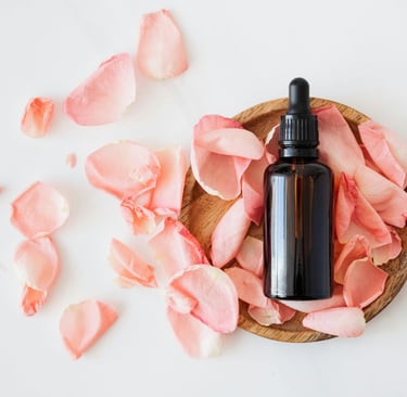 a bottle of essential oils on a wooden bowl