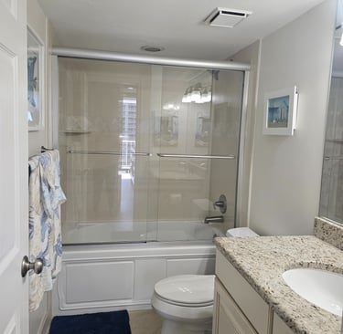 a bathroom with a shower and tub