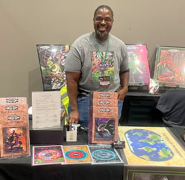 David Thompson, a smiling creator stands behind a table displaying EverLore tabletop roleplaying gam