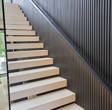 Modern floating staircase design with wide wood treads and vertical slat wall accent