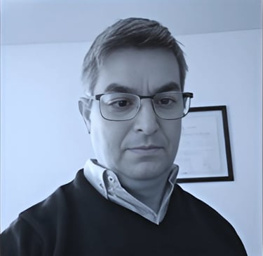 a man in glasses and a black sweater