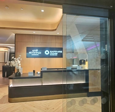 Chase Sapphire Lounge by The Club front desk and entrance with bar visible in background