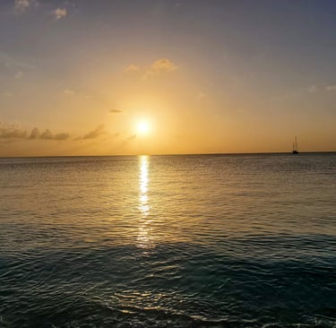 Jolly Beach Antigua – golden sunset over calm Caribbean water on Antigua's west coast