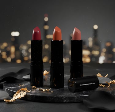 Three lipsticks shot against a dazzling cityscape.
