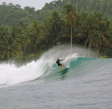 a surfer is riding a wave in the ocean of mentawai