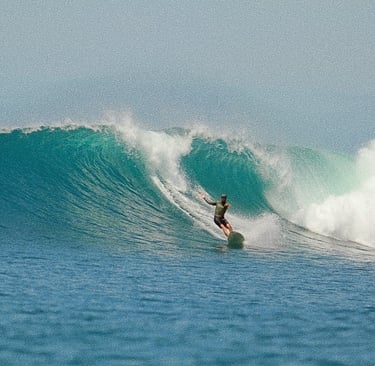a surfer is riding a wave in the ocean in siberut