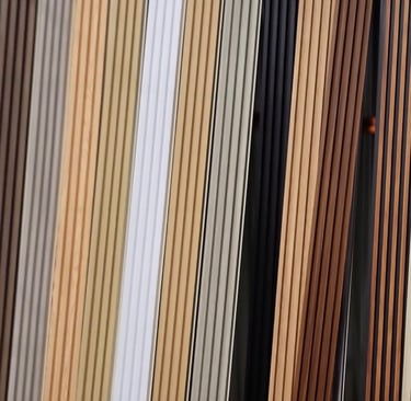 A variety of fluted wall panel samples in various wood tones and neutral colors for interior design.