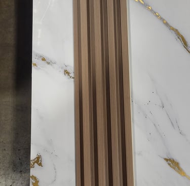 Wood slat wall panel sample placed over a white marble tile with gold veining for interior design.