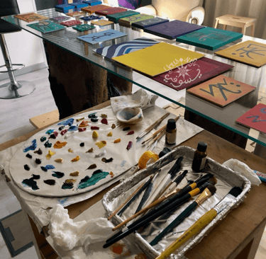 oil paints on palette and paintings by Artist Yous