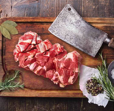 Fresh goat mutton curry cut on wooden board with herbs and spices.
