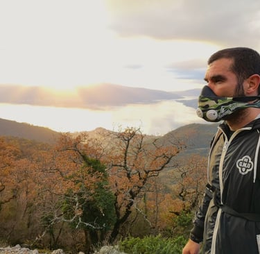 a man wearing a mask and a mask on a mountain