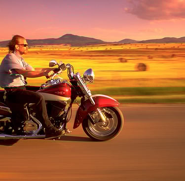 a man riding a motorcycle on a road