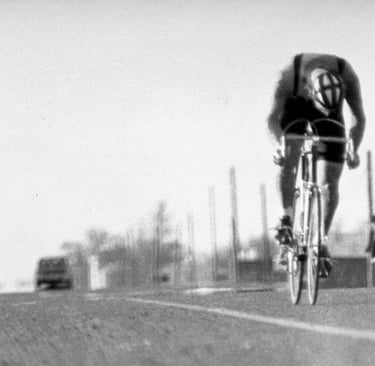 a man riding a bicycle on a road
