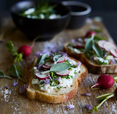 a wooden cutting board with a bowl of vegetables