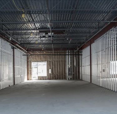 a large open space with a metal structure and a metal structure designed by Houston commercial contr