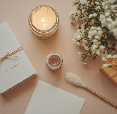 A collection of objects: a book, notecard, flowers