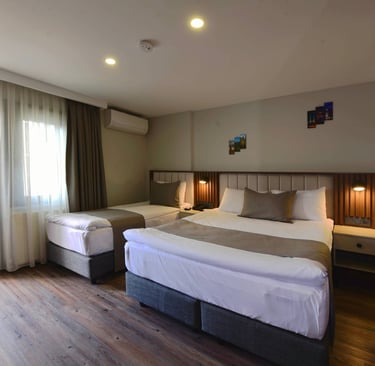 a hotel room with two beds and a balcony