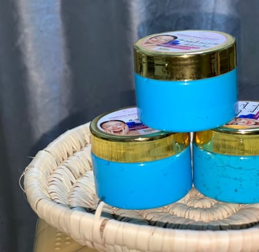 three jars of blue and gold colored paint on a wicker basket