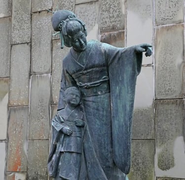 Statue of Miura Tamaki, the Japanese soprano famous for Madama Butterfly, standing in Glover Garden,