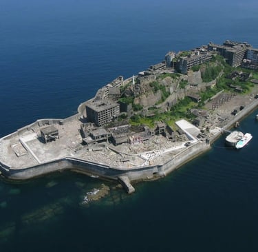 Aerial close-up view of Gunkanjima (Hashima Island), showing dense concrete apartment blocks and aba