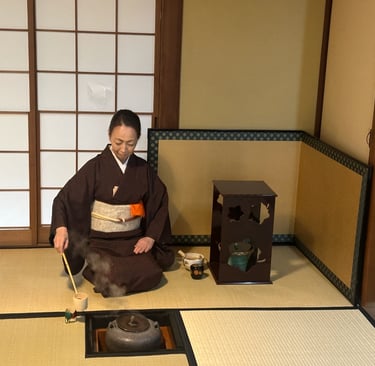 Woman preparing matcha tea during a traditional Japanese tea ceremony experience