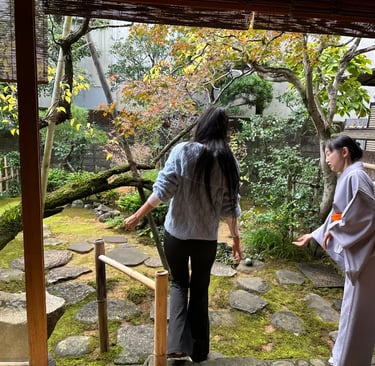 Woman receiving an introduction in a traditional tea garden during a Japanese tea ceremony experienc