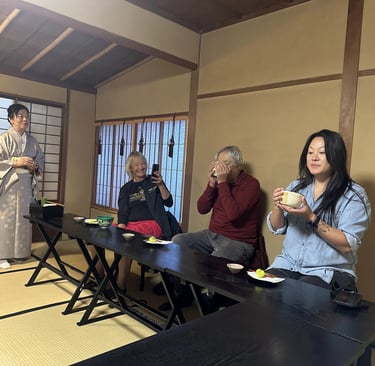 Family enjoying a traditional Japanese tea ceremony together in a tatami room.