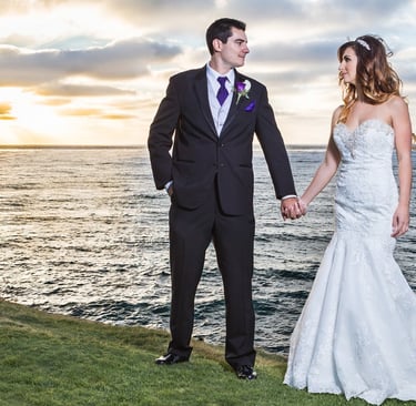 couple standing on the grass of Cuvier park in La jolla at sunset