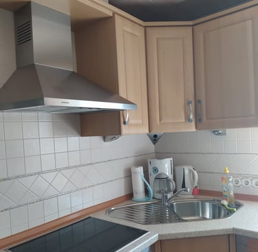 a kitchen with a stove top and a stove top